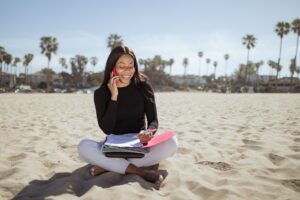 Woman on the phone at the beach