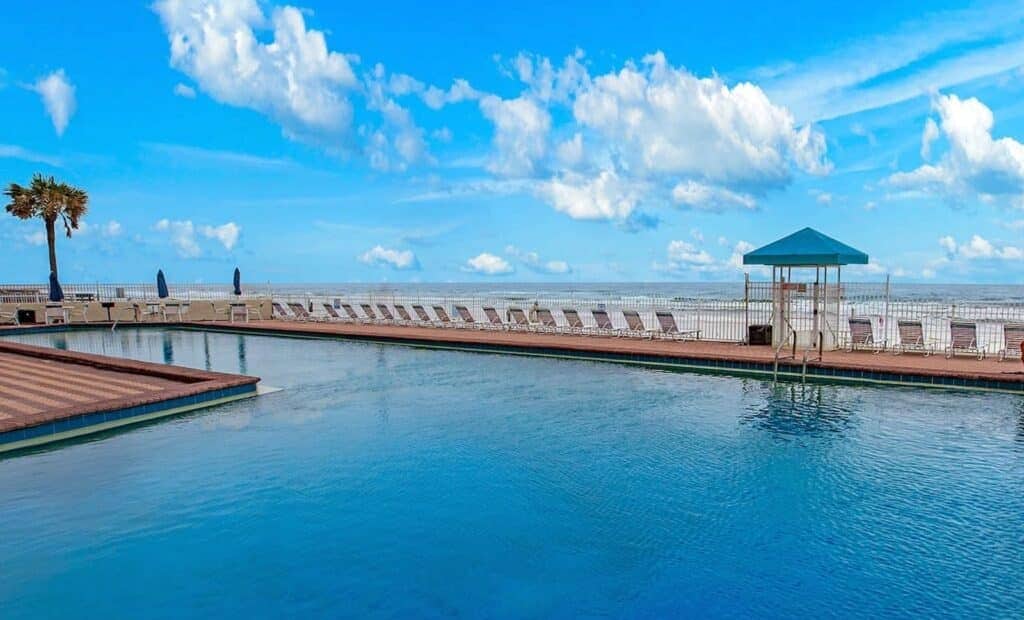 Oceanfront pool deck with direct beach access at Daytona Beach vacation rental