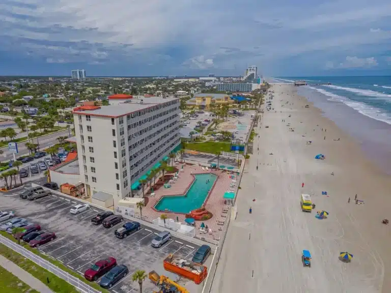 Illuminated neon archway and beachfront buildings at Daytona Beach vacation rental location
