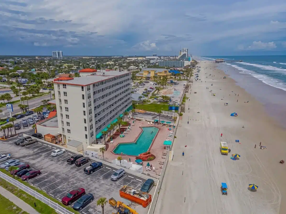 Illuminated neon archway and beachfront buildings at Daytona Beach vacation rental location